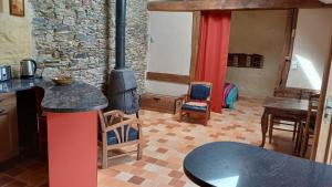 a kitchen with a stove in the middle of a room at gite art et nature in Thorigny