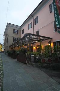 a building with awning on the side of it at Hotel Ristorante Fontana in Calestano