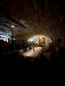 a dining room with a table and a bottle of wine at Hotel Ristorante Fontana in Calestano