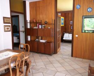 a dining room with a table and a room with a couch at Ca di Nà in Entracque