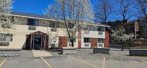 an empty parking lot in front of a building at Gardner Inn in Gardner
