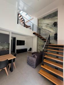 a living room with a staircase and a table at Luxekey ETTORE HOUSE in Scopello