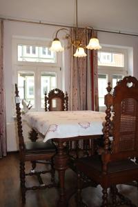 a dining room with a table and chairs and a window at Die gute Stube in Wernigerode