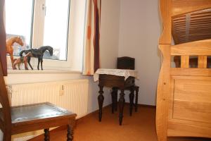 a room with a bed and a desk and a window at Die gute Stube in Wernigerode