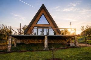 a house shaped like a triangle with a roof at Azad A-Frame in Şotrile