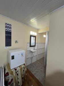 a bathroom with a sink and a mirror at Pousada Rural João De Barro 1 in Capela Ivapurunduva