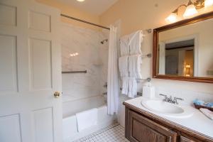 a bathroom with a sink and a shower and a mirror at Beaumont Inn in Harrodsburg