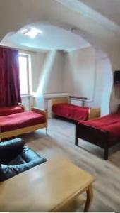 a living room with two beds and a table at Hotel Meridiane in Bakuriani