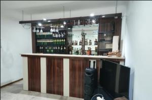 a bar with a flat screen tv in front of it at Hotel Meridiane in Bakuriani