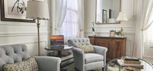 a living room with two chairs and a table at The Mason Cottage Downtown in Cape May