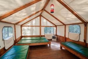 a room with two beds and two windows at Sundance By Basecamp in Kananaskis Village
