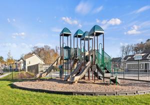 a playground with a slide in a park at Modern Townhouse with Pool Gym & Tennis Near Beach in Ocean View