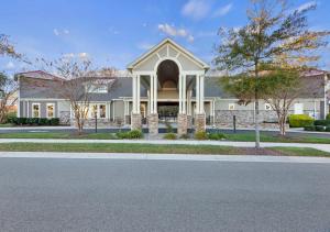 a large white building with an arched doorway at Modern Townhouse with Pool Gym & Tennis Near Beach in Ocean View