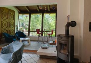 a living room with a fireplace and a table with chairs at Ca di Nà in Entracque