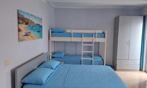 a bedroom with two bunk beds and a ladder at Sea & Sky apartment in Skataj