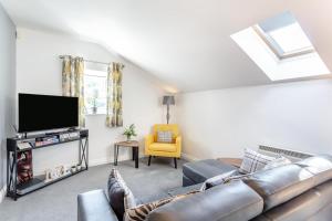 a living room with a couch and a tv at 1 Bed in Holmfirth oc-88554 in Holmfirth