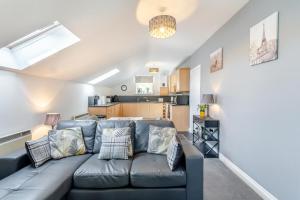 a living room with a couch and a kitchen at 1 Bed in Holmfirth oc-88554 in Holmfirth