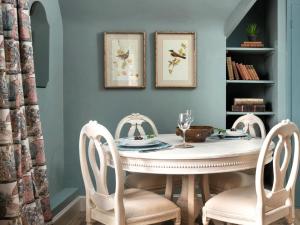 a dining room with a white table and chairs at Whistler Rooms in Peterborough
