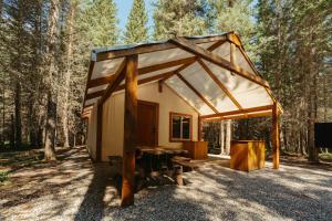 a small tent with a table in the woods at Sundance By Basecamp in Kananaskis Village +36 photos