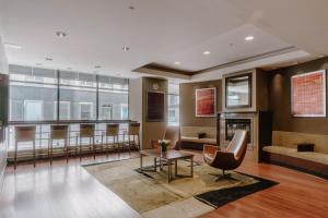 a lobby with a waiting room with a table and chairs at Club Quarters Hotel Central Loop, Chicago in Chicago