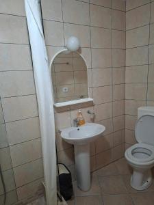 a bathroom with a sink and a toilet at Apartman Perast in Perast +12 photos