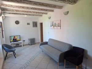 a living room with a couch and a tv at Apartman Perast in Perast