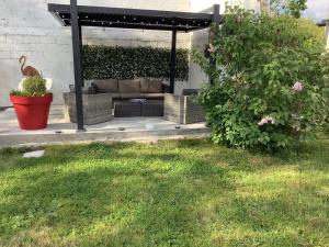 a patio with a couch under a gazebo at Studio chic avec parking in Calais