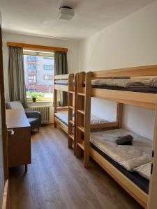 a room with three bunk beds and a desk at O Tom Nevim in Sušice