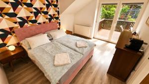 a bedroom with a bed and a colorful wall at Hilltop Apartments in Fonyód