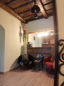 a living room with two chairs and a table at STĀRĶA APARTAMENTI in Kuldīga