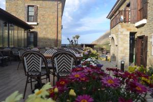 a group of chairs sitting at a table with flowers at Mathilda Gökçeada in Gokceada Town