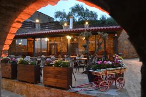 a restaurant with a flower cart in front of it at Mathilda Gökçeada in Gokceada Town