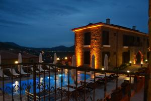 a view of a building with a swimming pool at night at Mathilda Gökçeada in Gokceada Town +7 photos