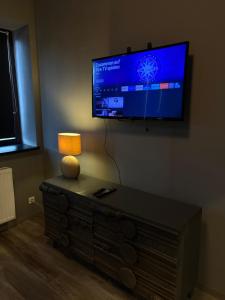 a living room with a flat screen tv on a wall at Smartstay Porta in Porta Westfalica