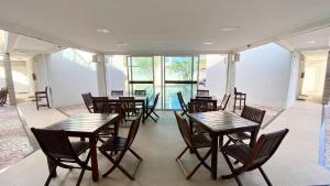 a dining room with wooden tables and chairs at Terraço Hotel Lagoinha in Lagoinha