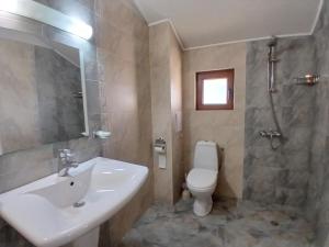 a bathroom with a sink and a toilet at Zenith Guest House in Sozopol