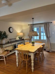 a dining room with a wooden table and chairs at Barley House, Sea and Beach Facing Accommodation in Southwold