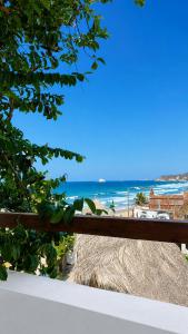 a view of the beach from a fence at Casa Arena, Zipolite Playa del Amor in Zipolite