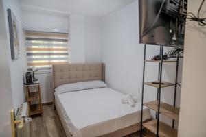 a small bedroom with a bed and a tv at Hostale Blas Cabrera Madrid in Madrid