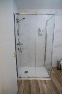 a shower with a glass door in a bathroom at Hostale Blas Cabrera Madrid in Madrid +31 photos