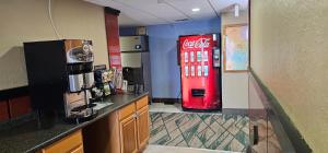 a cocacola soda machine in a room with a counter at Gardner Inn in Gardner