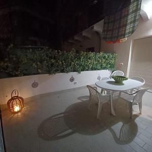 a table and two chairs and a table and a lamp at Taormina Naxos Home 2 in Giardini Naxos