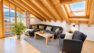 a living room with a couch and a table at AlpStern Ferienwohnungen Oberstdorf in Oberstdorf