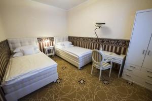 a bedroom with two beds and a desk and a chair at Golden Royal Boutique Hotel & Spa in Košice +65 photos