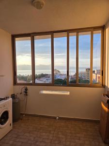 a room with a window with a view of a city at Appartamento Polidea in Reggio di Calabria