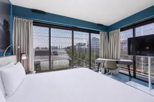 a hotel room with a large bed and a large window at Radisson Blu Hotel Bordeaux in Bordeaux