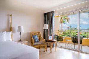 a hotel room with a bed and a balcony at Iberostar Selection Playa Mita - All Inclusive in Punta Mita