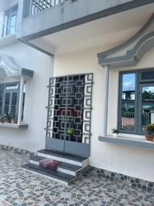 a front door of a house with a window at inoru house in Siliguri