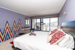 a bedroom with a large bed with a mural on the wall at Skyline Living, Table Mountain Views in Cape Town +10 photos