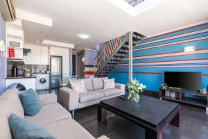 a living room with a couch and a table at Skyline Living, Table Mountain Views in Cape Town